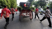 Kereta kencana yang membawa keluarga calon mempelai melintas menuju Gedung Graha Saba Buana.