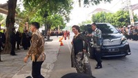 Susi tampak mengenakan kebaya warna hitam dan kain batik corak putih untuk bawahan
