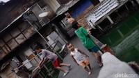 Anak-anak bermain di jembatan di atas Kali Cideng.