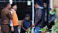 Wawan berjalan meninggalkan ruang sidang sambil tertawa.