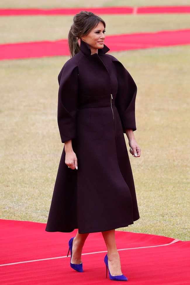 Permainan berbusana Melania Trump berlanjut ke Seoul, Korea Selatan. Melania mengenakan coat Delpozo yang dramatis dengan bagian lengan bulky. Coat berikut dibanderol dengan harga 3.124 pounds atau Rp 55 jutaan. Busana ini disempurnakan high heels Christian Louboutin berwarna ungu seharga 495 pounds atau Rp 8,7 juta. Foto: Dok. Getty Images