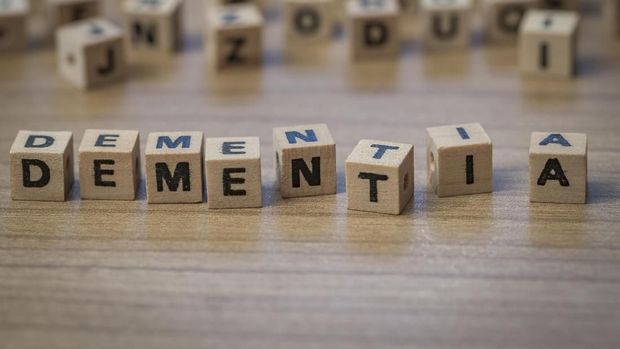 Dementia written in wooden cubes on a table from well ordered to chaotic