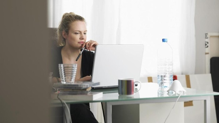 Woman using laptop sitting at office
