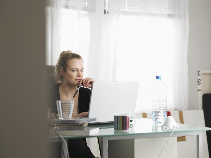 Woman using laptop sitting at office