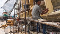 Salah satu buruh sedang memperbaiki geladak kapal.
