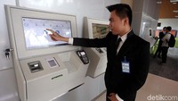 Petugas menunjukan cara membeli tiket kereta bandara.