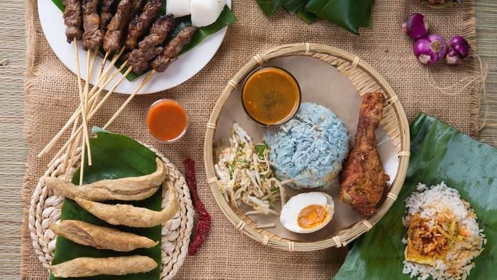 Nasi kerabu Traditional Malaysian food. Nasi kerabu is a type of nasi ulam, popular Malay rice dish. Blue color of rice resulting from the petals of butterfly-pea flowers. Asian cuisine.
