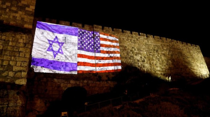 An Israeli national flag and an American one are projected on a part of the walls surrounding Jerusalems Old City December 6, 2017. REUTERS/Ronen Zvulun