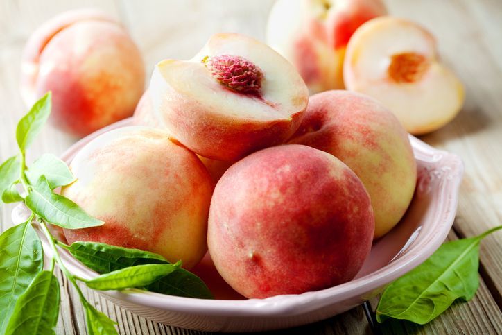 Group of fresh peaches on wooden background