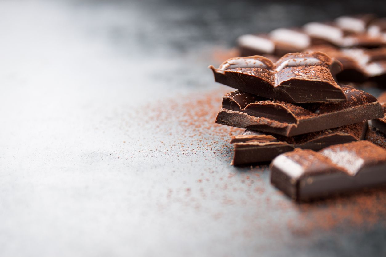 Chocolate background. Many pieces of chocolate, candies, cookies, biscuits, cakes and other sweets. Milk chocolate and dark chocolate. coconut candy