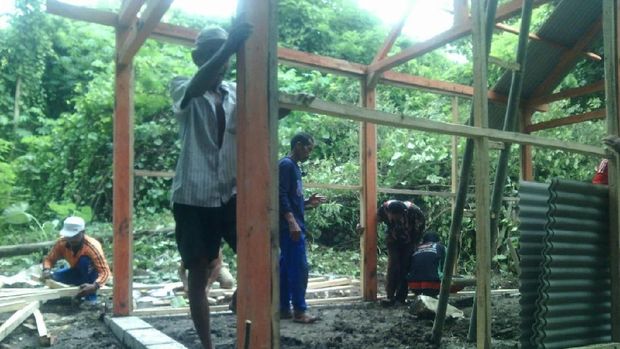 Para tukang sedang membangun rumah baru untuk Mbah Panidin
