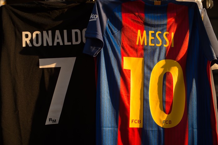 MADRID, SPAIN - AUGUST 16: The shirts of Cristiano Ronaldo of Real Madrid CF and Lionel Messi of FC Barcelona are for sale at a stall outside the Santiago Bernabeu stadium ahead of the Supercopa de Espana Final 2nd Leg match between Real Madrid and FC Barcelona at Estadio Santiago Bernabeu on August 16, 2017 in Madrid, Spain. (Photo by Denis Doyle/Getty Images)