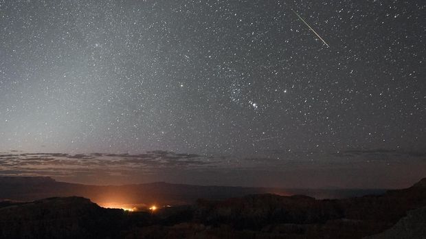 BRYCE CANYON NATIONAL PARK, UT - AUGUST 12: A Perseid meteor streaks across the sky above Inspiration Point early on August 12, 2016 in Bryce Canyon National Park, Utah. The annual display, known as the Perseid shower because the meteors appear to radiate from the constellation Perseus in the northeastern sky, is a result of Earth's orbit passing through debris from the comet Swift-Tuttle. Ethan Miller/Getty Images/AFP