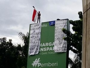 Seorang Pria Panjat Baliho di Depan Mabes Polri