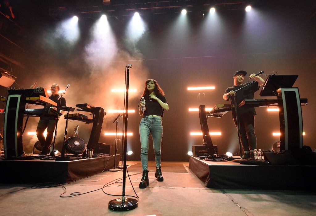 LAS VEGAS, NV - APRIL 21:  (L-R) Recording artist/producer Iain Cook, singer Lauren Mayberry, and recording artist/producer Martin Doherty of Chvrches perform at Brooklyn Bowl Las Vegas on April 21, 2016 in Las Vegas, Nevada.  (Photo by Ethan Miller/Getty Images)
