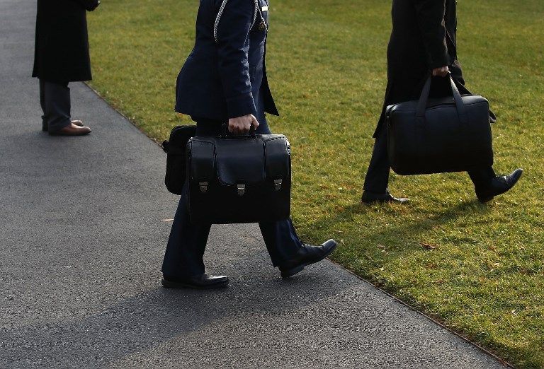 WASHINGTON, DC - DECEMBER 02: A military aide carries the nuclear football as he walks toward Marine One to depart with U.S. President Donald Trump., on December 2, 2017 in Washington, DC. President Donald Trump is traveling to New York city to attend meetings with the Republican National Committee.   Mark Wilson/Getty Images/AFP