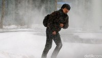 Seorang warga nekat beraktivitas di tengah badai di Massachusetts, AS. Brian Snyder/Reuters.