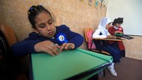 Anak-anak tampak antusias saat belajar membaca huruf braille di dalam kelas. REUTERS/Alaa Al-Marjani.
