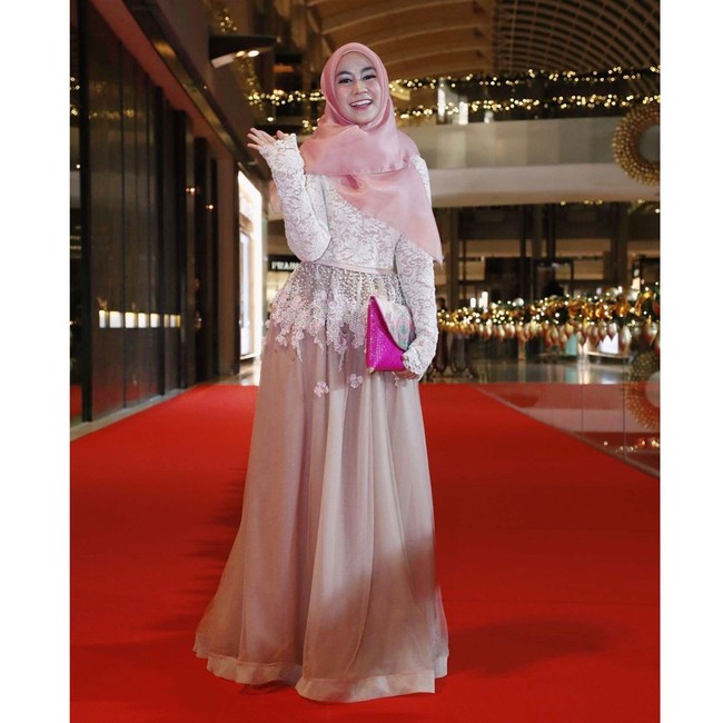 Anisa Rahma tampil cantik dan anggun dalam balutan dress bermaterial brokat dan organza yang elegan. Kerudung organza merah muda semakin memberikan sentuhan feminin serta kalem. Foto: Dok. Instagram @anisarahma_12
