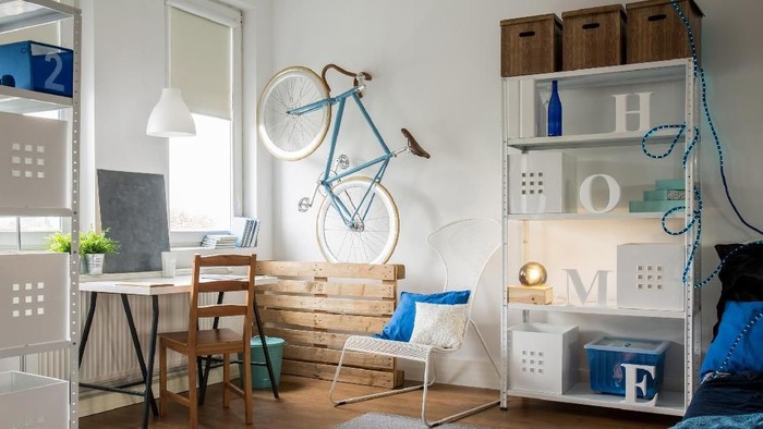 Very small modern studio flat with blue sofa, cozy kitchen  and bright details