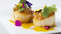 Kalau ini scallop dengan saus jeruk dan jahe. Sajian khas Prancis ini jadi lebih berwarna karena penambahan edible flower. Foto: Istimewa
