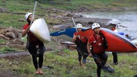 Sumita Kurnia, atlet dayung di nomor kayak slalom single putri bersama dua rekannya tengah membawa perahu serta dayungnya setelah menjalani latihan ringan. (dok. Kemenpora)