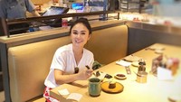 Saat sendiri, Yuni juga meluangkan waktu untuk kulineran. Ia mencicip sushi sambil mencari bahan jas untuk kedua anaknya. Foto: Instagram yunishara36