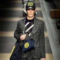 Fendi juga menampilkan gaya memakai tas yang tren di kalangan pria. Bukan backpack, tapi front pack, yakni tas yang diselempangkan di bagian depan. Foto: AFP