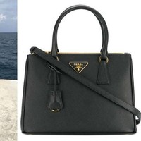 Bupati Rita berpose membawa tas Prada berukuran mini seharga US$ 2.124 atau sekitar Rp 28 juta. Foto: Dok. Facebook, Prada.