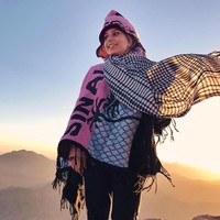 Menginjak gurun pasir di Mesir, Haifa Basseiso memilih kain bermotif sorban lengkap dengan ponco dari kain rajut. Foto: Instagram