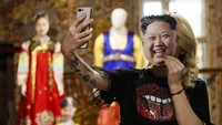 Salah satu pengunjung selfie dengan memakain topeng Kim Jong Un