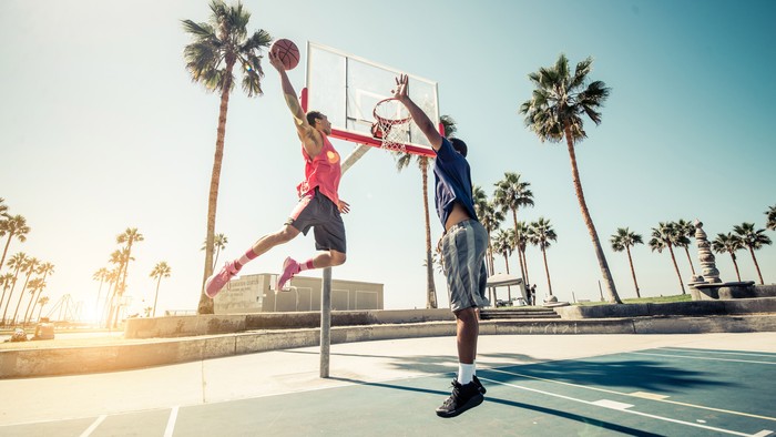 Friends playing basketball - Afro-american players having a friendly match outdoors