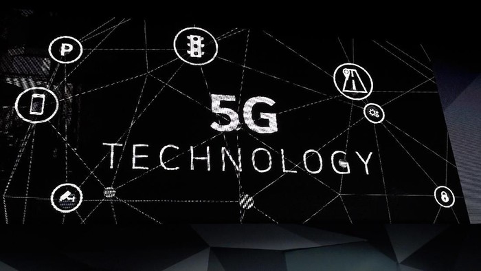 LAS VEGAS, NV - JANUARY 08:  An attendee photographs a 5G logo display during a Qualcomm press event for CES 2018 at the Mandalay Bay Convention Center on January 8, 2018 in Las Vegas, Nevada. CES, the worlds largest annual consumer technology trade show, runs from January 9-12 and features about 3,900 exhibitors showing off their latest products and services to more than 170,000 attendees.  (Photo by David Becker/Getty Images)