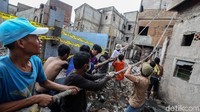 Warga merobohkan rumah yang terlanjur rusak akibat kebakaran.