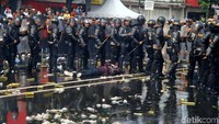 Simulasi ini menggambarkan polisi sedang mengamankan provokator.