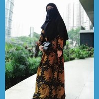 Seperti saat pergi ke kondangan, Wafiq Malik tetap memakai busana resmi seperti dress batik. Ia mengombinasikan dress batik berwarna keemasan dengan hijab cadar berwarna hitam. Foto: Instagram/WafiqMalik
