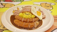 Nasi berwarna kuning yang disajikan dengan kuah kari. Ditambah dengan beberapa potong sosis, bacon dan telur. Gemas! Foto: Istimewa