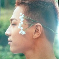 Taeyang berpose dengan sepetik bunga putih, menggambarkan nuansa rustic. Foto: dok. Dazed