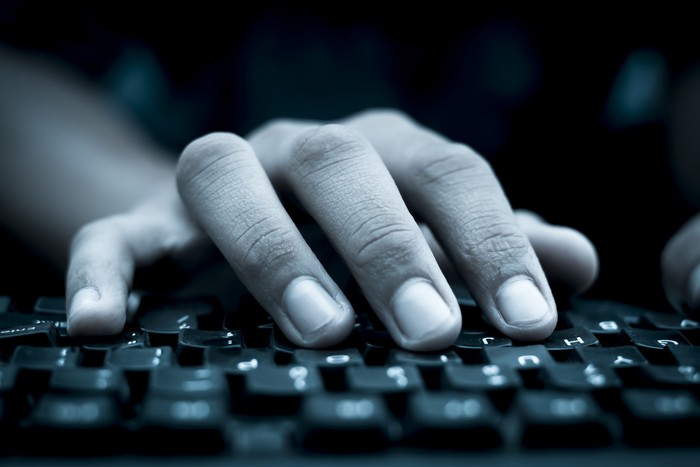 Human hand on keyboard,isolated, selective focus, shallow depth of field, concept of work & technology.