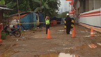 Foto: Polisi dan seorang berpakaian hitam terlihat berjaga di depan area masuk proyek. Sementara tidak ada satu pun orang yang berada di dalam dekat lokasi jatuhnya crane itu.Fotografer: Ibnu Hariyanto/detikcom