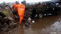 Petugas Suku Dinas Kebersihan DKI Jakarta alias Pasukan Oranye membersihkan sampah sisa banjir tersebut.