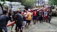 Proses pengangkutan tiang listrik untuk 3 desa di Pulau Buru. Pool/PLN Wilayah Maluku dan Maluku Utara.