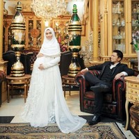 Oki Setiana Dewi juga bergaya ala ratu dan raja bersama suaminya. Ia mengenakan gaun mewah putih dipadukan dengan hijab sifon berwarna senada. Foto ini diabadikan oleh Impresi Fotografi. Foto: Instagram