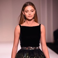 Wanita asal Afrika Selatan ini juga tampil tak kalah cantik dengan makeup bernuansa nude dan rambut yang ditata lurus. Ia mengenakan mini dress dengan aksen bulu-bulu nan atraktif. Foto: Getty Images