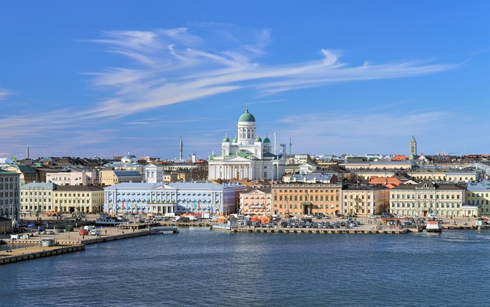 Helsinki, Finland. Scenic cityscape with Helsinki Cathedral, South Harbor, Market Square (Kauppatori) and beautiful cirrus clouds over them in the sunny spring day.