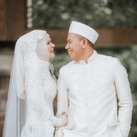 Acara akad nikah diselenggarakan di Masjid Istiqlal Jakarta Pusat. Angel Lelga mengenakan kebaya modern berwarna putih dipadukan dengan kain batik sidomukti. Hijabnya yang simple dibuat spesial dengan tambahan veil bertabur swarovski dan headpiece yang elegan. Foto: Instagram