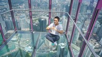 KL Tower atau Menara Kuala Lumpur punya spot balkon berlantai kaca yang menantang adrenalin. Kamu berani berfoto seperti Randy? (randpunk/Instagram)