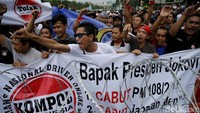 Para pendemo terlihat memebawa atribut seperti spanduk dan poster.