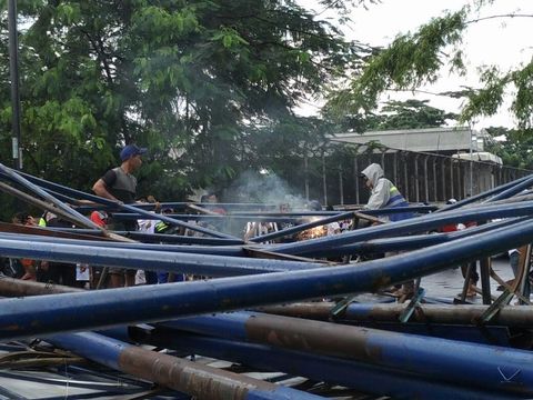 Petugas memotong reklame yang roboh