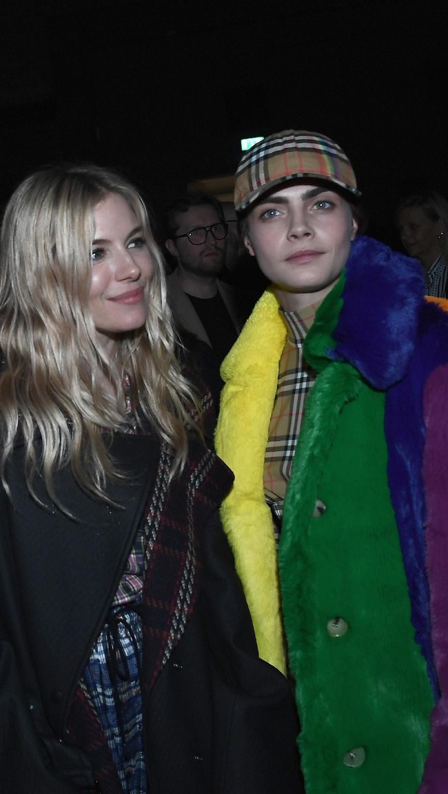 Di belakang panggung, Cara sempat berfoto bersama aktris dan model Sienna Miller. (Foto: Getty Images)